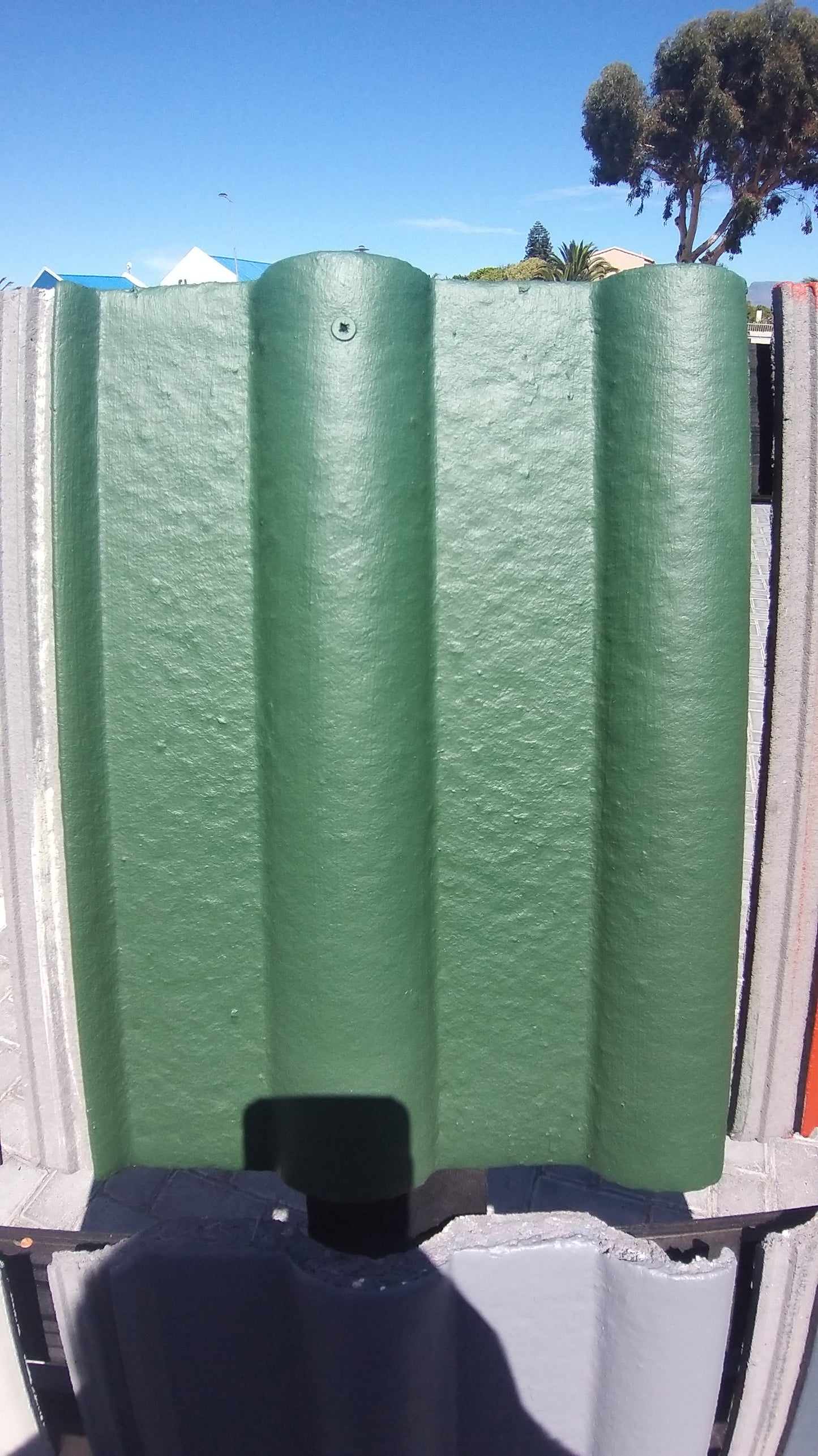 Roof tile painted with Green Oxide Rhinoluxe Shield waterproof paint