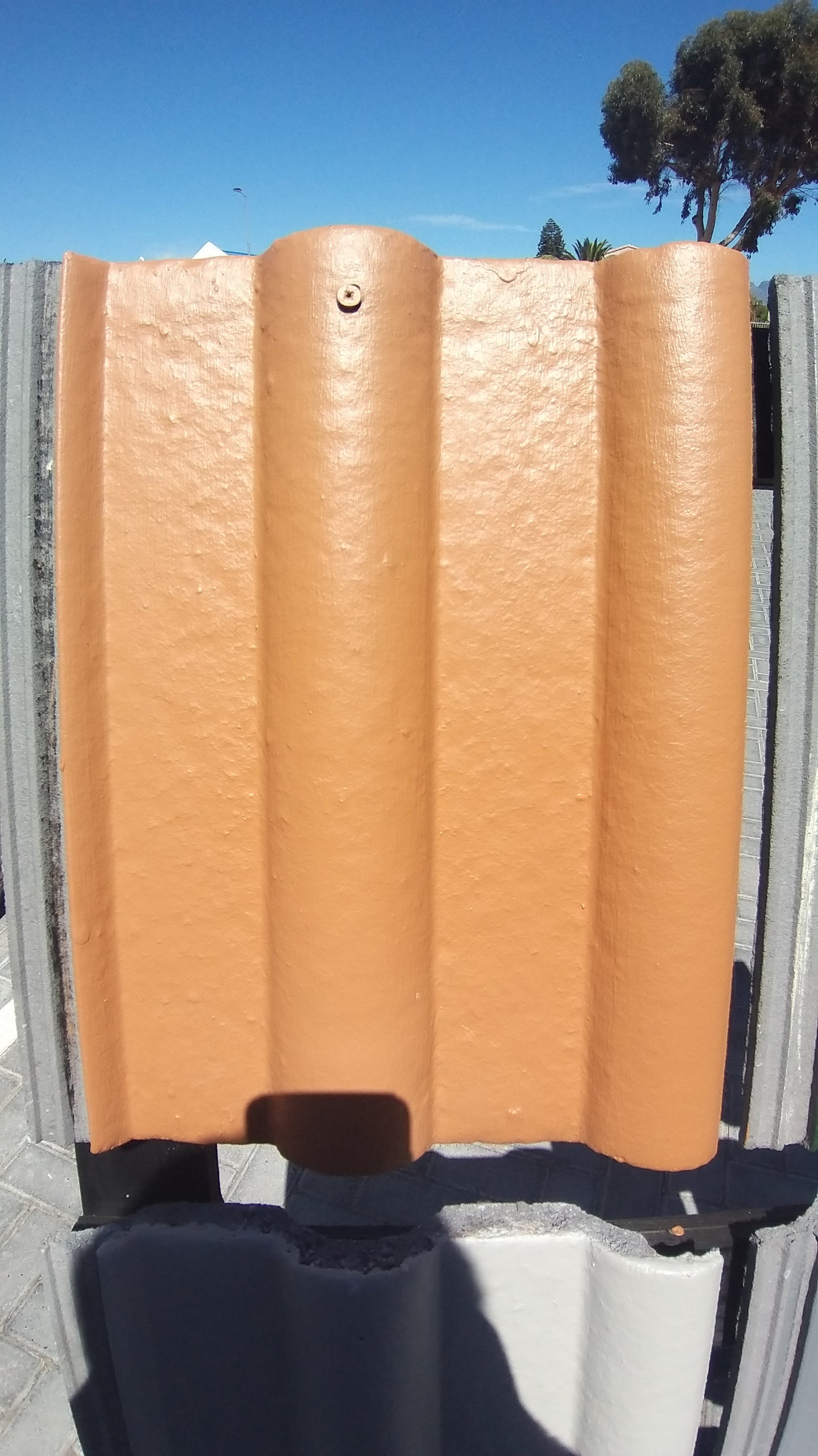 Roof tile painted with Terracotta Rhinoluxe Shield waterproof paint