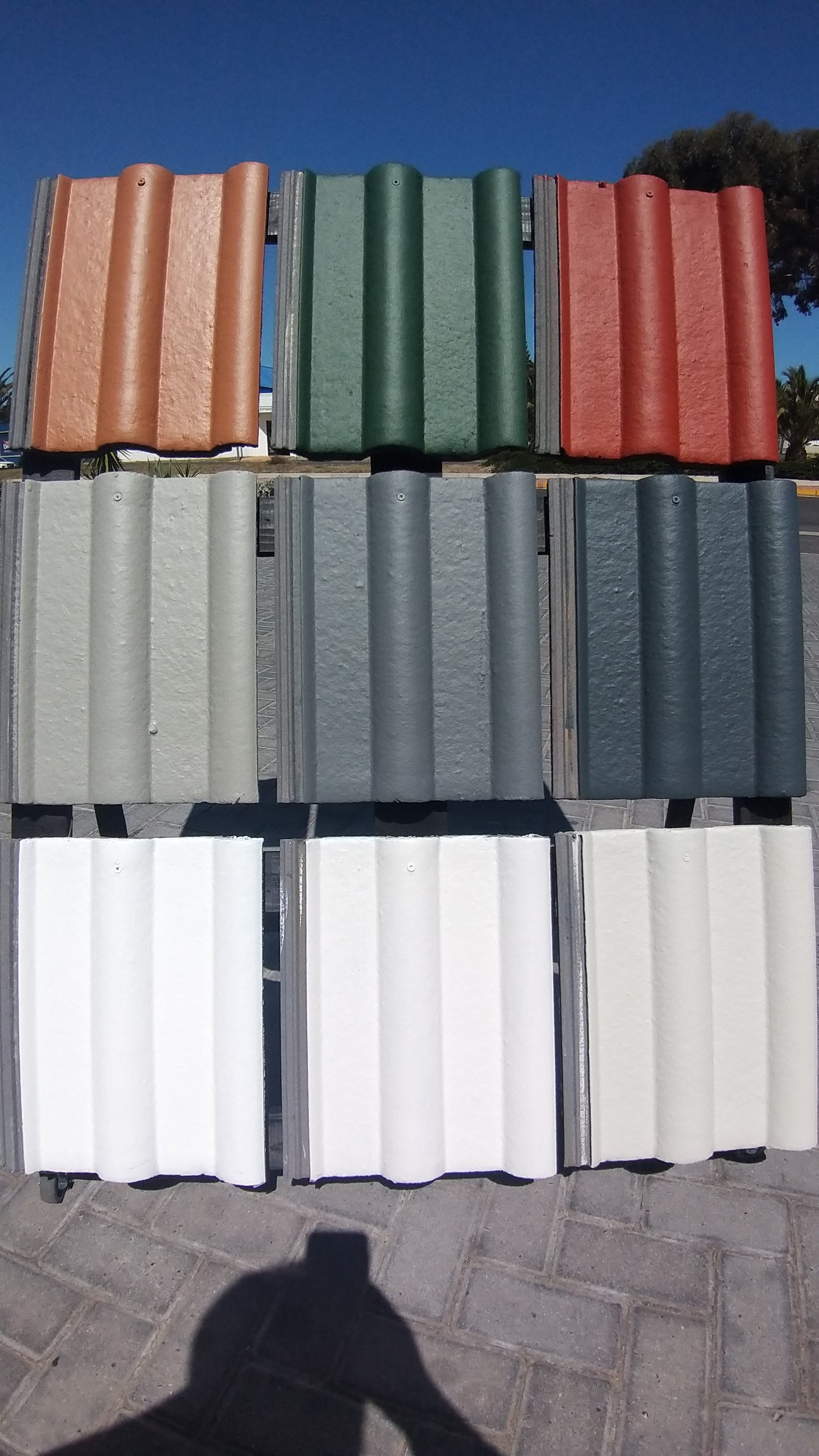 Roof tiles painted with Rhinoluxe Shield waterproof paint in multiple colours