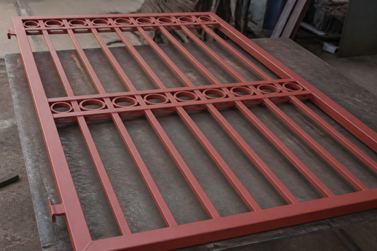Steel gate section coated in red oxide metal primer