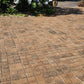 Completed brick paver driveway sealed with Rhinoluxe Stone Sealer with garden landscaping