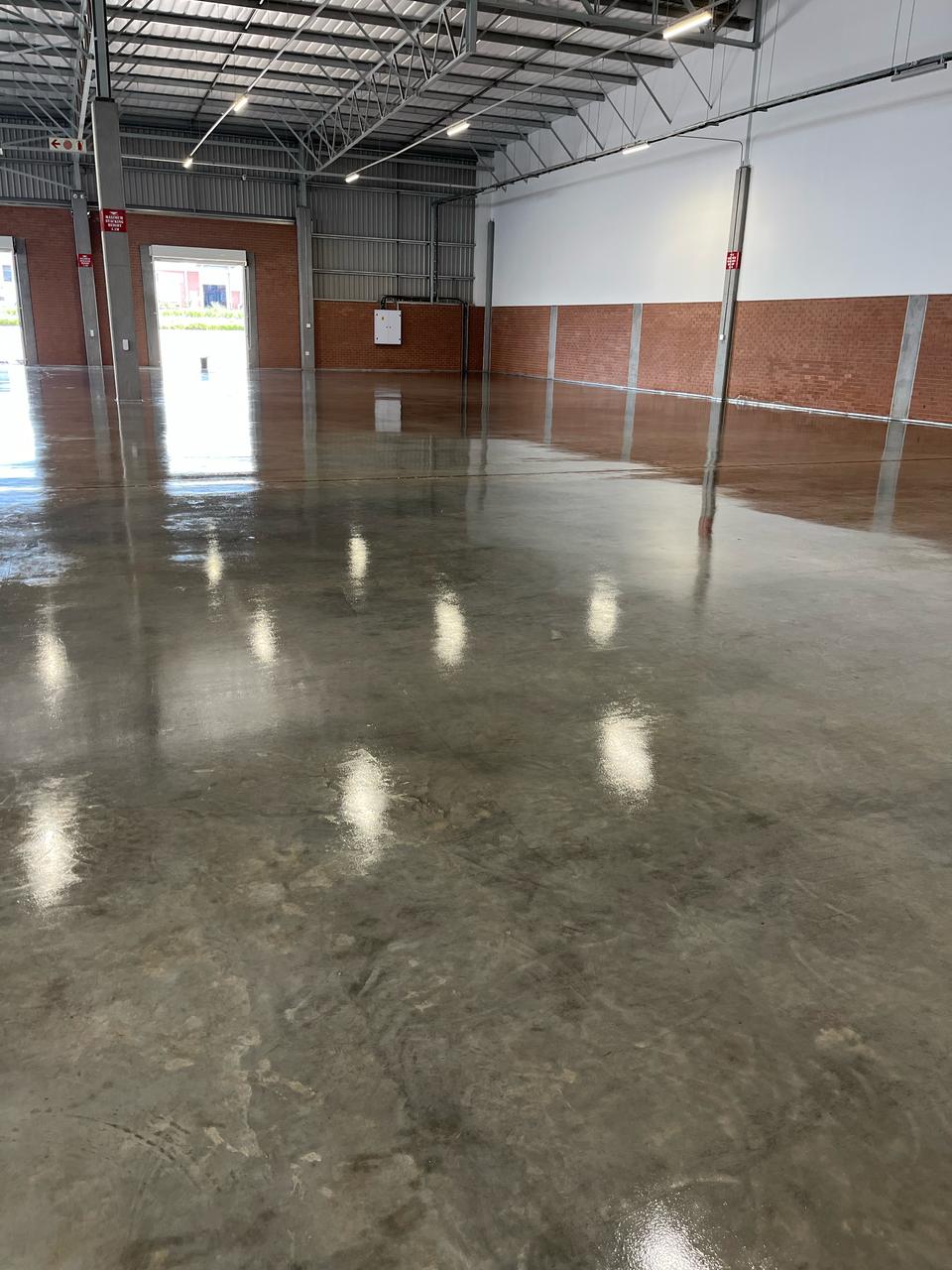 Stone Sealer on warehouse floor showing durable high-gloss concrete protection