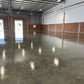 Wide-angle view of warehouse with Rhinoluxe Stone Sealer applied to entire concrete floor