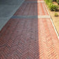 Sealed red clay pavers with glossy satin finish outside commercial building entrance