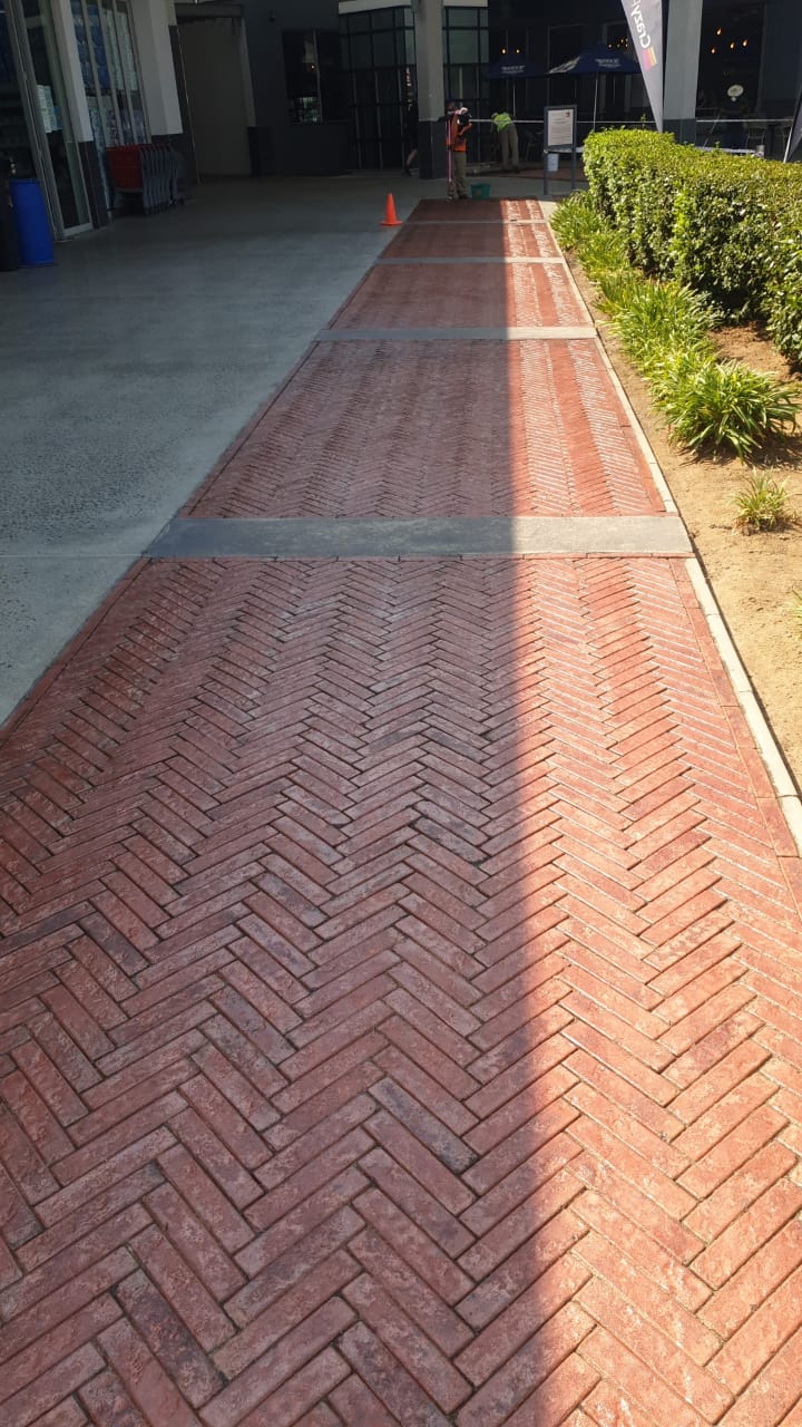 Sealed red clay pavers with glossy satin finish outside commercial building entrance
