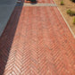 Rhinoluxe Stone Sealer satin finish on red brick paving at mall entrance with bollards