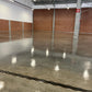 Warehouse concrete floor with professional stone sealer application and satin-gloss sheen