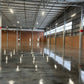 Reflective sealed concrete warehouse floor demonstrating stone sealer gloss performance