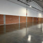 Industrial floor sealed with Rhinoluxe Stone Sealer showing smooth high-gloss concrete finish