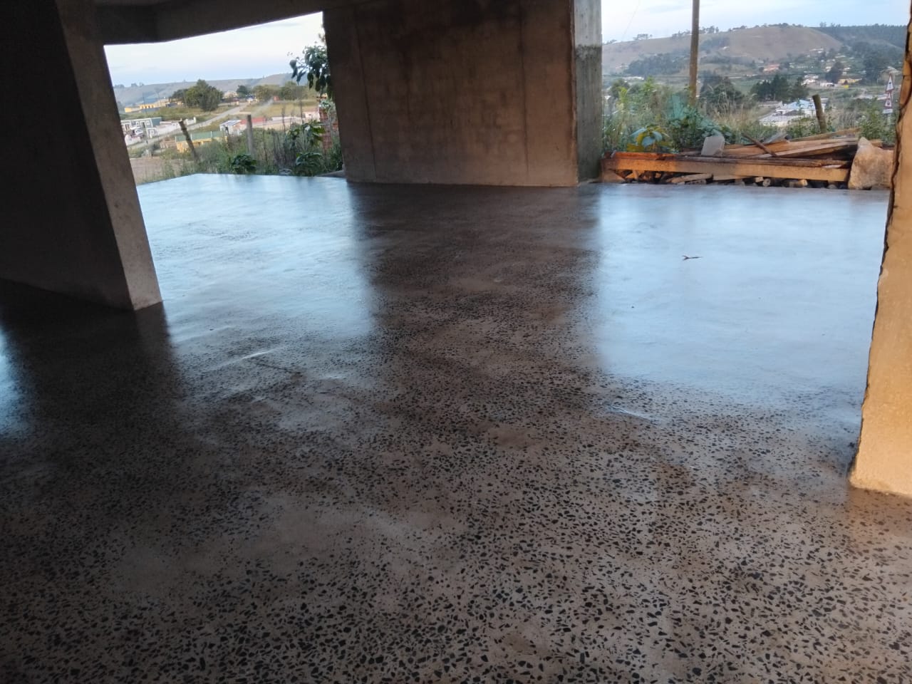 Polished concrete floor with a scenic outdoor view in the background. Floor treated with Stone Sealer